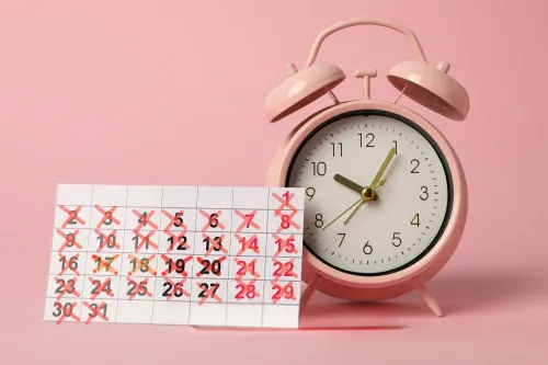A woman holding her forehead in visible stress, symbolizing the impact of stress on menstrual health.