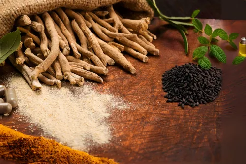 A rustic display of natural thyroid remedies including ashwaganda roots, turmeric powder, black cumin seeds, peppermint leaves, and herbal supplements.