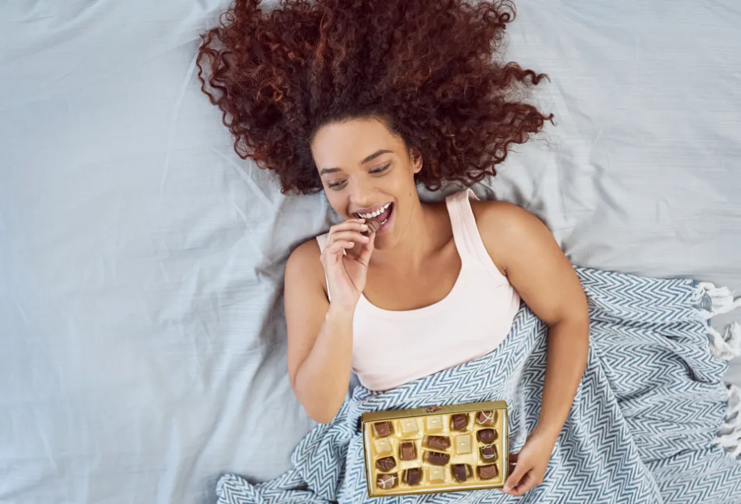 Woman Eating Chocolate During Period